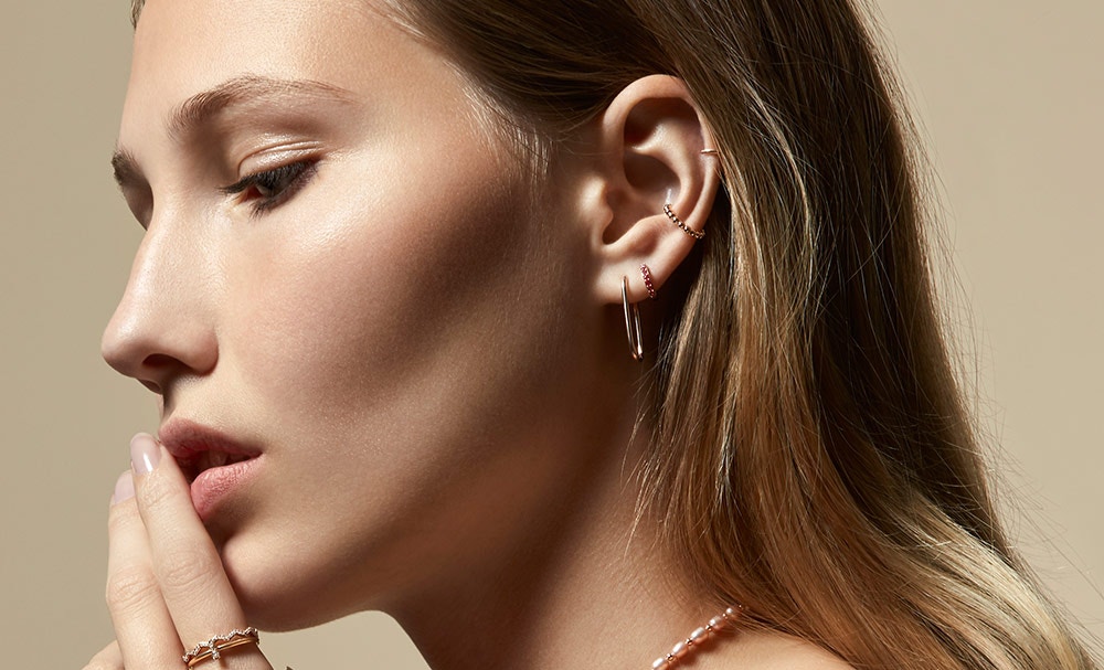 Model wearing the Beaded Stilla Ear Cuff in Yellow Gold Vermeil layered with the Mini Halo Pink Sapphire Single Hoop Earring in Rose Gold | The Astley Clarke Blog