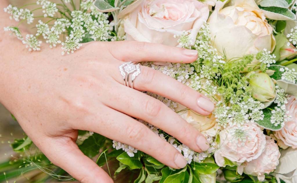 Hand model wearing Astley Clarke Interstellar Axel and Cluster Diamond Rings in Solid Gold