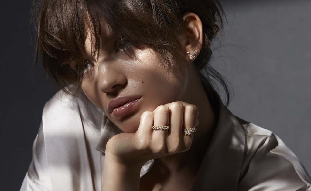 Model wearing 14 carat solid gold and diamond jewellery from the Astley Clarke Comet collection