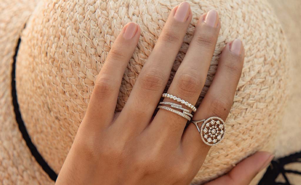 Model wears the Astley Clarke Biography White Sapphire Eternity Ring in sterling silver with other Astley Clarke White Gold and Diamond Rings