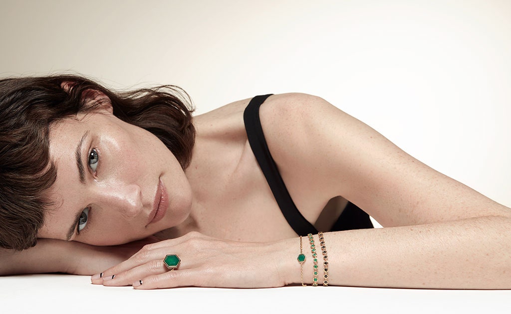 Model wearing Astley Clarke Deco collection in yellow gold vermeil with green agate gemstones