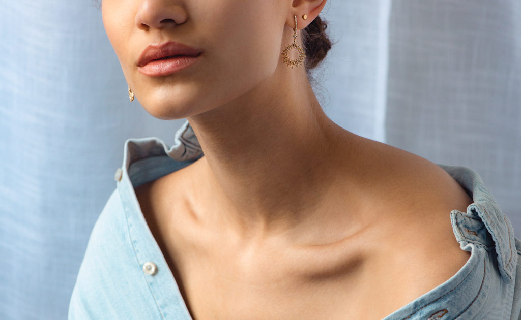 Model wearing Astley Clarke Comet Burst Diamond Drop Earrings in Solid 14ct Yellow Gold