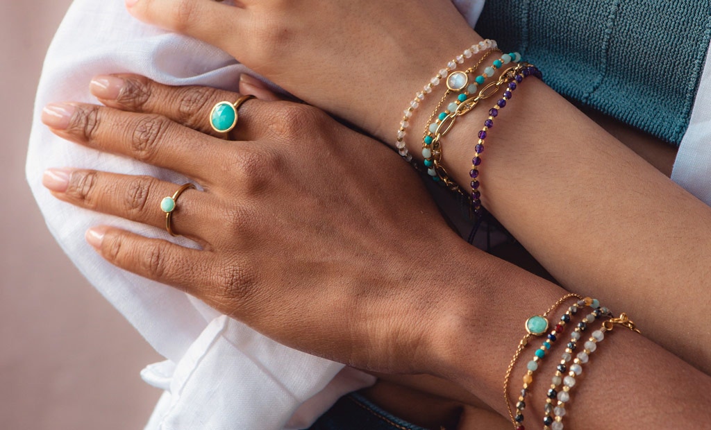 Models wearing Astley Clarke Biography Gemstone Friendship Bracelets in 18ct gold vermeil