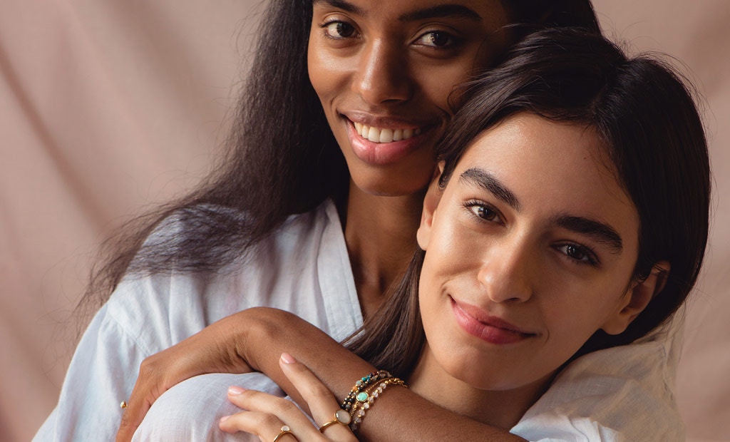 Models wearing Astley Clarke Biography Gemstone Friendship Bracelets in 18ct gold vermeil