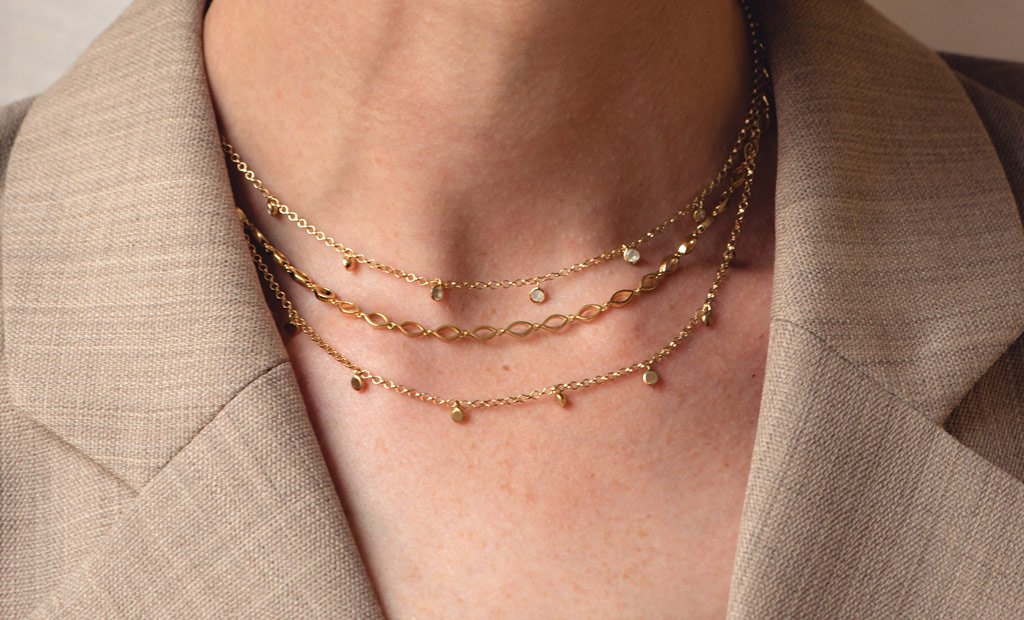 Model wearing Astley Clarke Evil Eye Chain Necklace and Biography Moonstone Double Droplet Necklace in 18ct Yellow Gold Vermeil