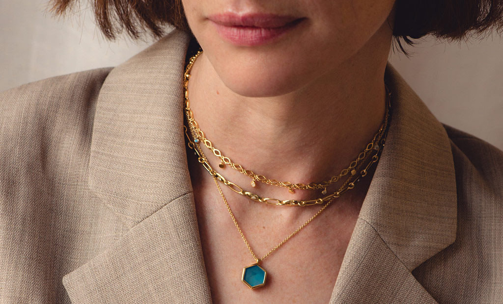 Model wearing Astley Clarke Gemstone and Chain Stacking Necklaces in 18ct Yellow Gold Vermeil