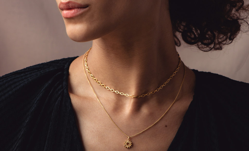 Model wearing Astley Clarke Rejuvenate Necklace Stack in 18ct Yellow Gold Vermeil