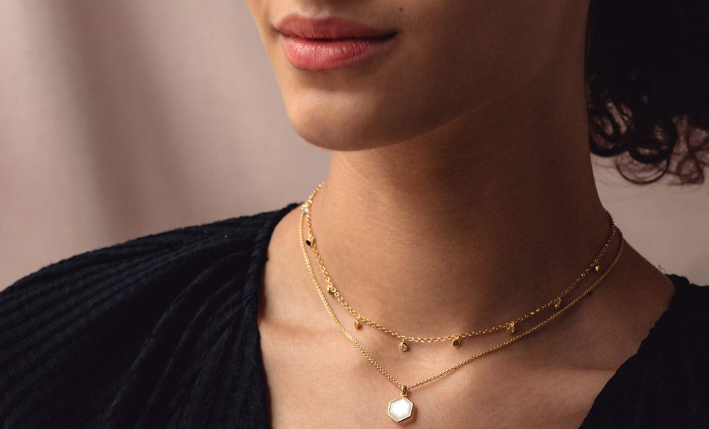 Model wearing Astley Clarke Deco Moonstone Pendant Necklace and Moonstone Droplet Necklace in 18ct Yellow Gold Vermeil