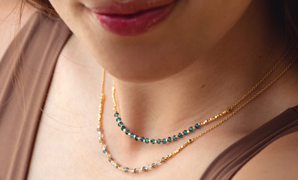 Model wearing Astley Clarke Beaded Gemstone Stacking Necklaces in 18ct Gold Plated Sterling Silver