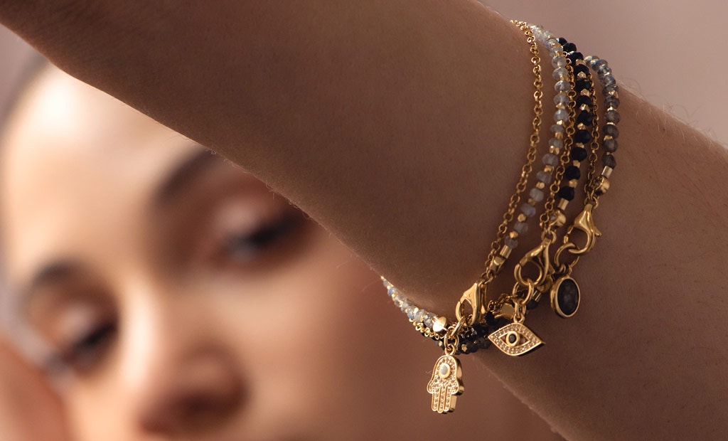 Model wearing Astley Clarke Gemstone Biography Charm Stacking Bracelets in 18ct Gold Vermeil