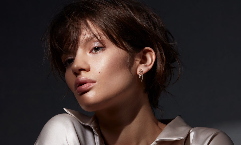 Model wearing Astley Clarke Comet Diamond Drop Earrings in solid 14ct Gold