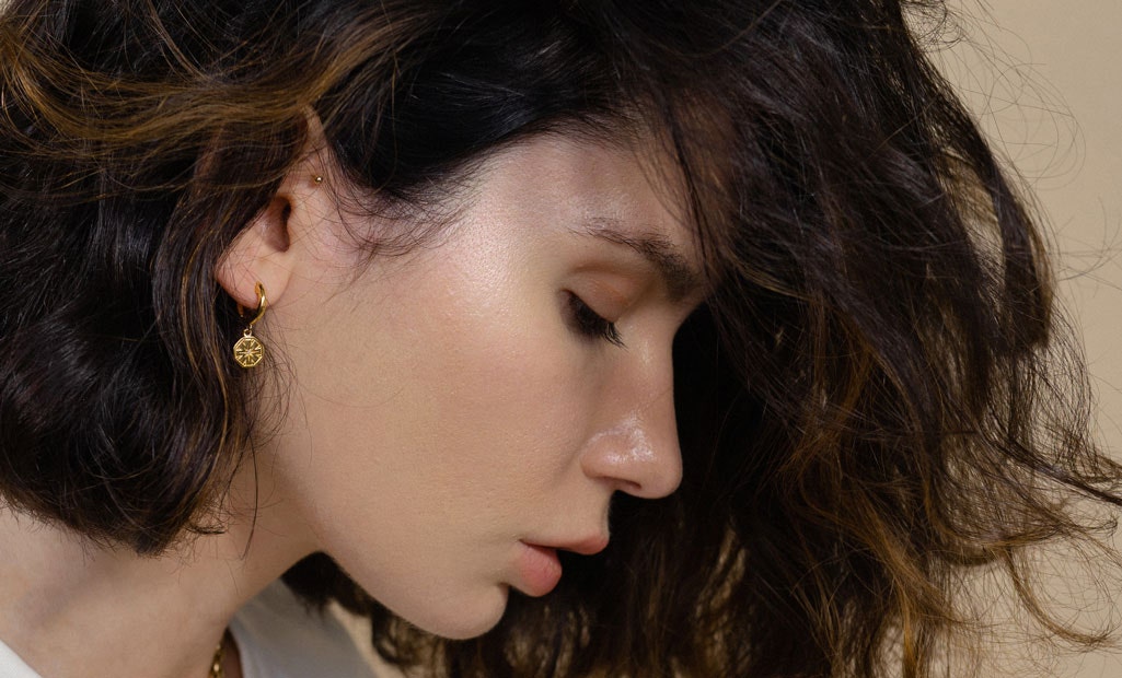 Lolita Mas wearing the Celesital Dial Drop Hoop Earrings in 18ct yellow gold vermeil