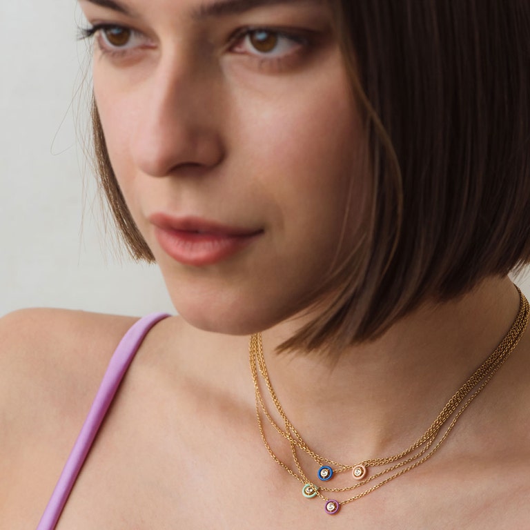 layered gold necklaces with pastel coloured enamel with sapphires
