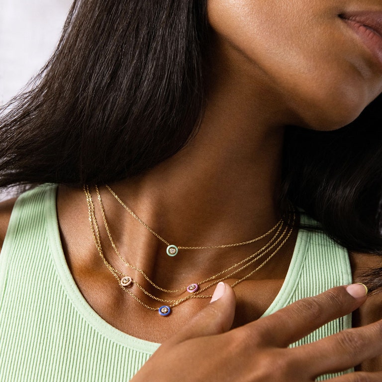 layered gold necklaces with pastel coloured enamel with sapphires
