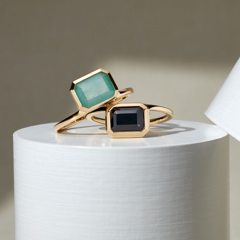 stacked gold rings with blue and black gemstone 