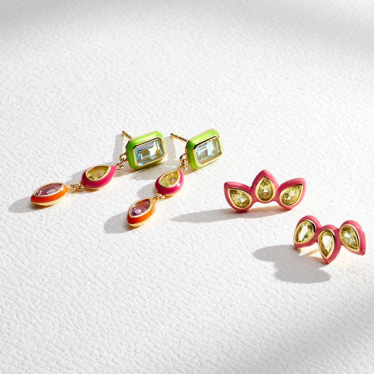 still life image of statement earrings with colourful drop earrings and neon stud earrings