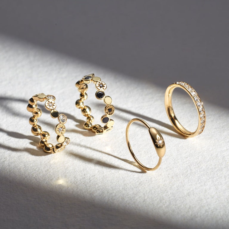 still life image of gold eternity stacking rings