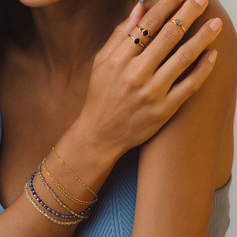 gold ring with black gemstones