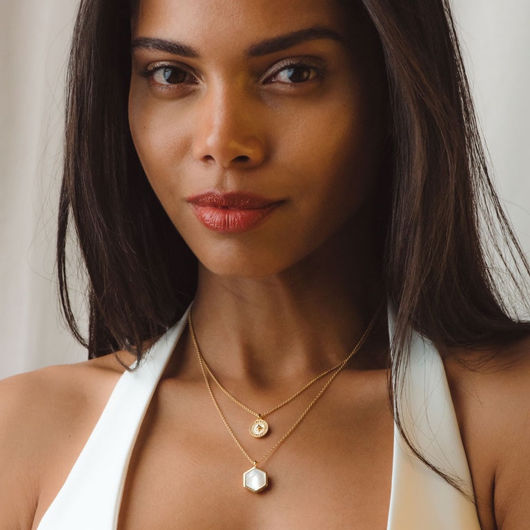 gold locket necklace with mother of pearl gemstone and gold pendant necklace
