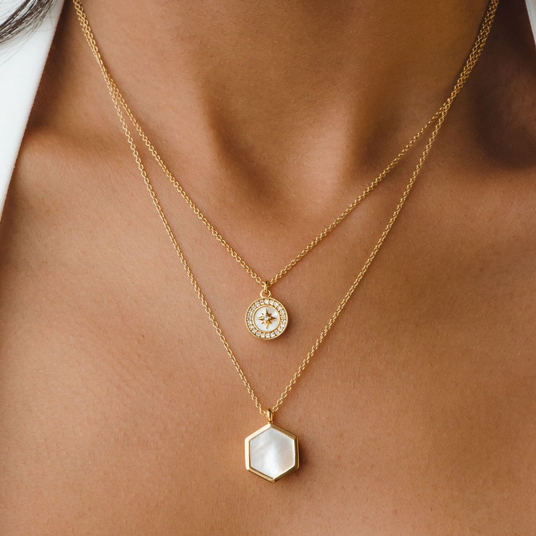 gold pearl necklace stack with mother of pearl pendant necklace and pearl locket necklace