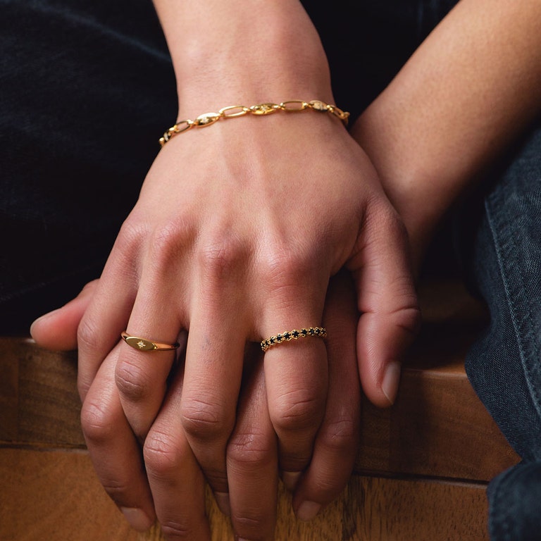 gold jewellery with gold signet ring, gold chunky chain bracelet and black gemstone eternity ring