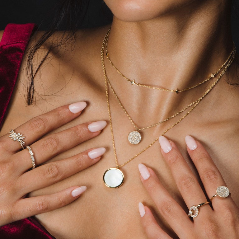 solid gold diamond ring with dainty star choker necklace and diamond locket necklace