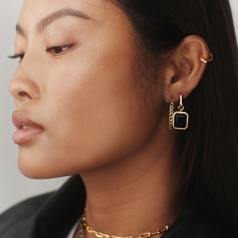 black gemstone statement earring with black hoop earring in yellow gold vermeil