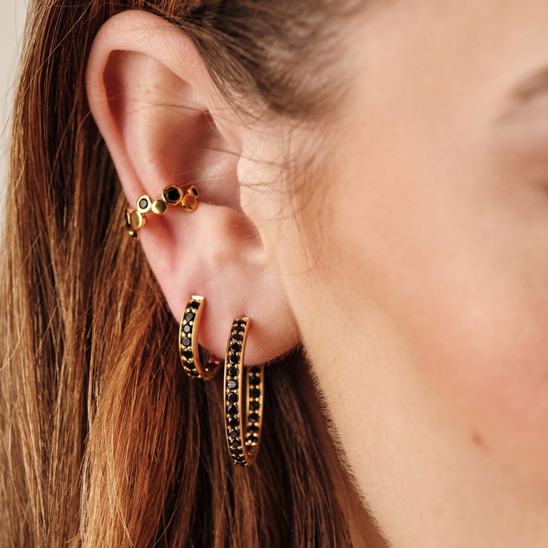 black spinel hoop earring stack with gold ear cuff