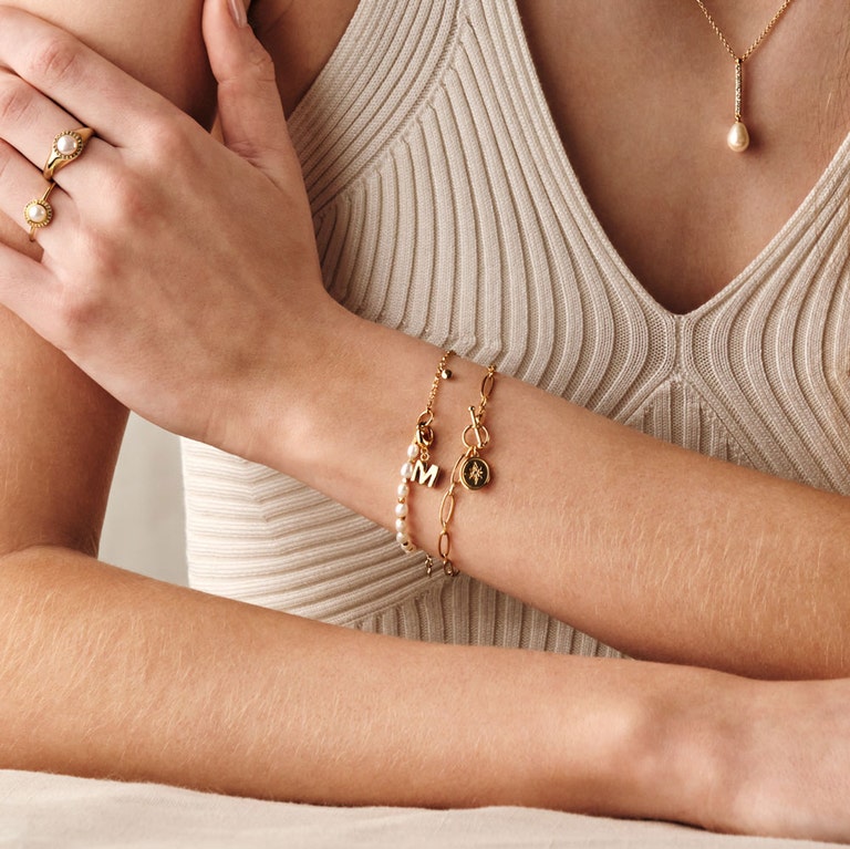 gold t-bar bracelet with pearl charm bracelet and gold pearl stacking rings