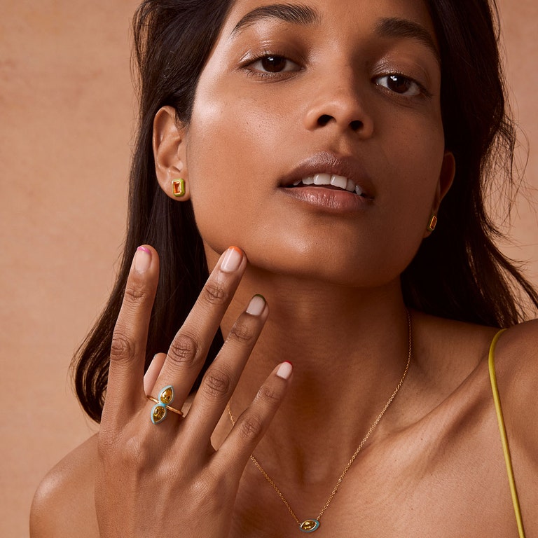 gold cocktail ring in blue enamel with citrine gemstone and gold stud earrings with green enamel
