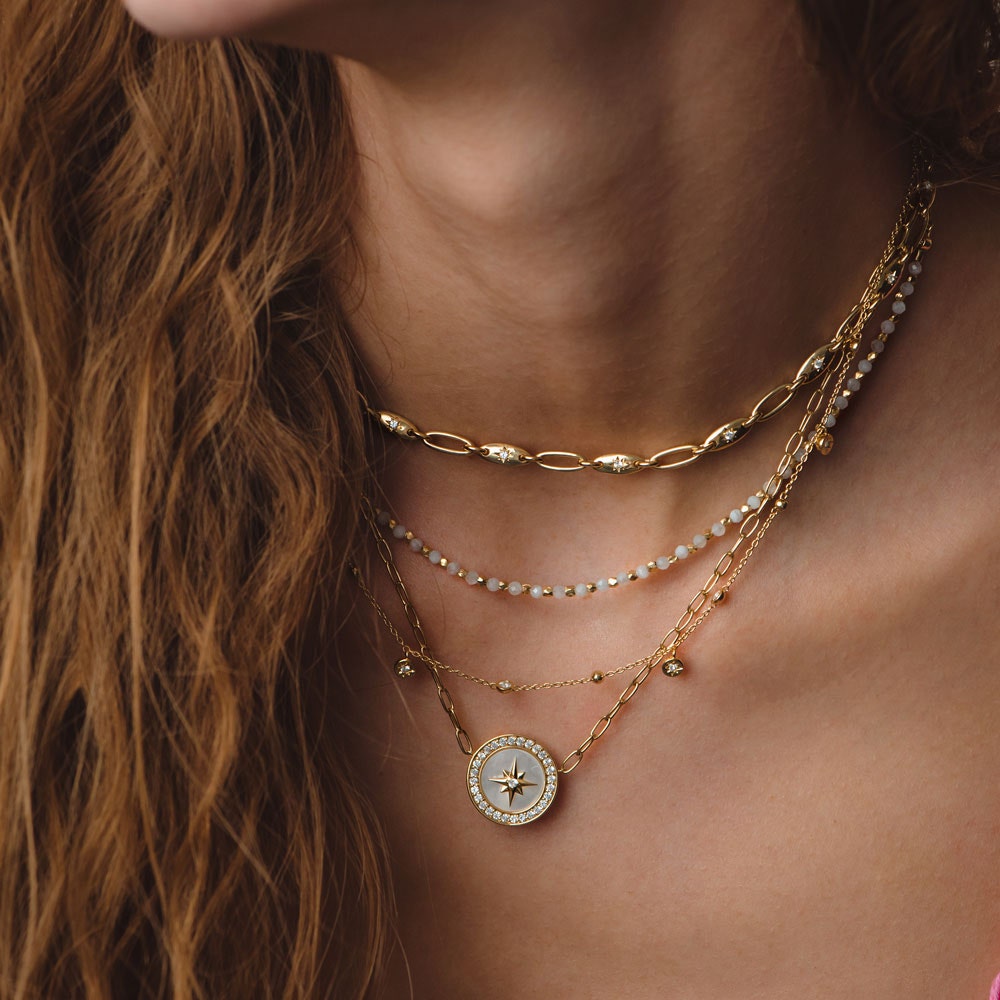 gold necklace stack with mother of pearl necklace, moonstone choker and orbit chain