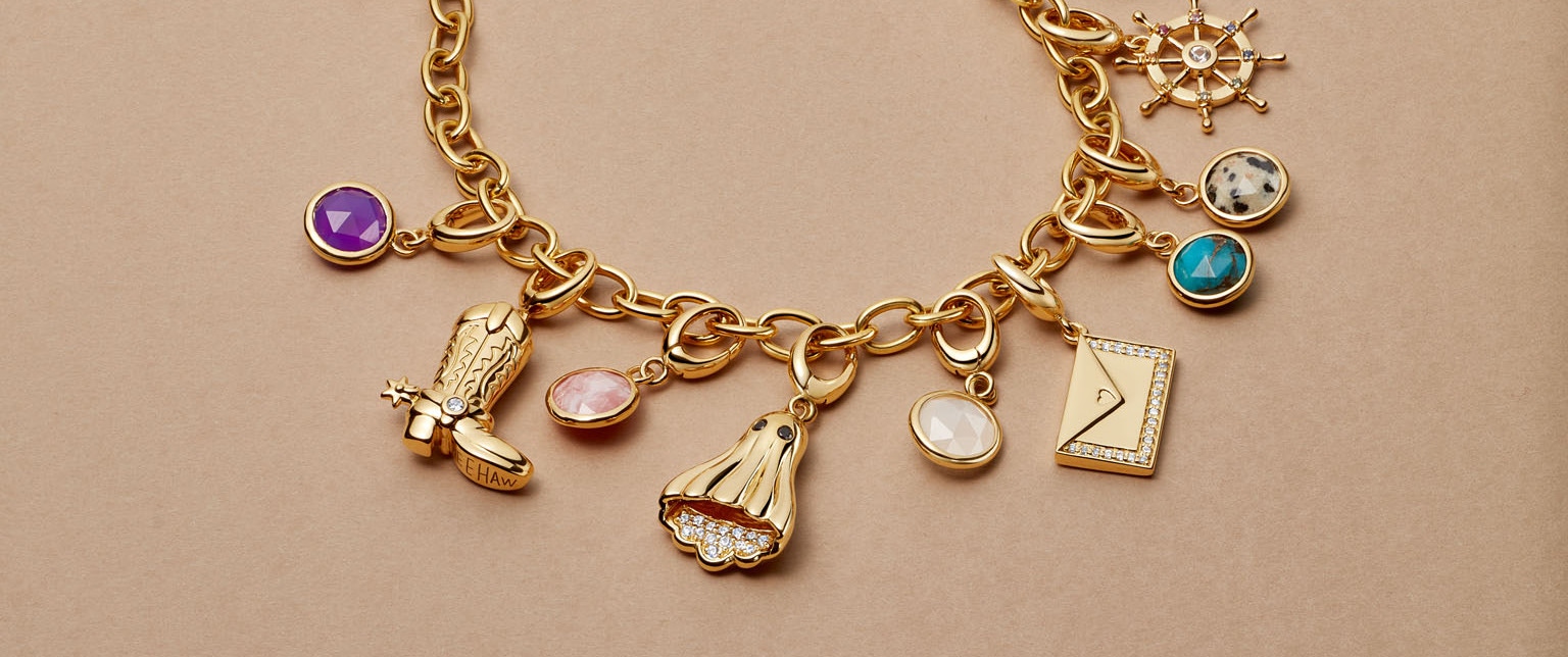 Gold jewelry stack with engraved locket