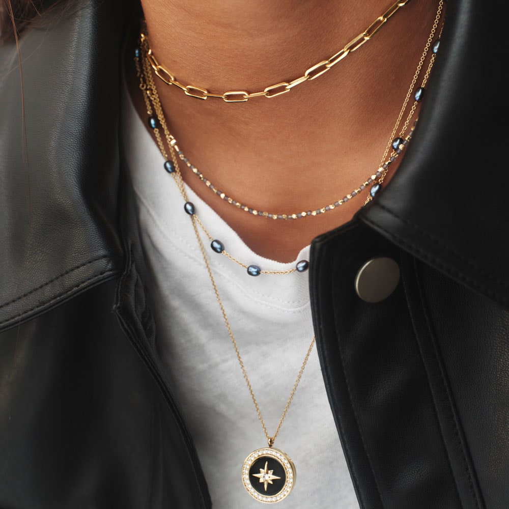 necklace stack with black onyx locket, pearl necklace, iolite choker and gold choker