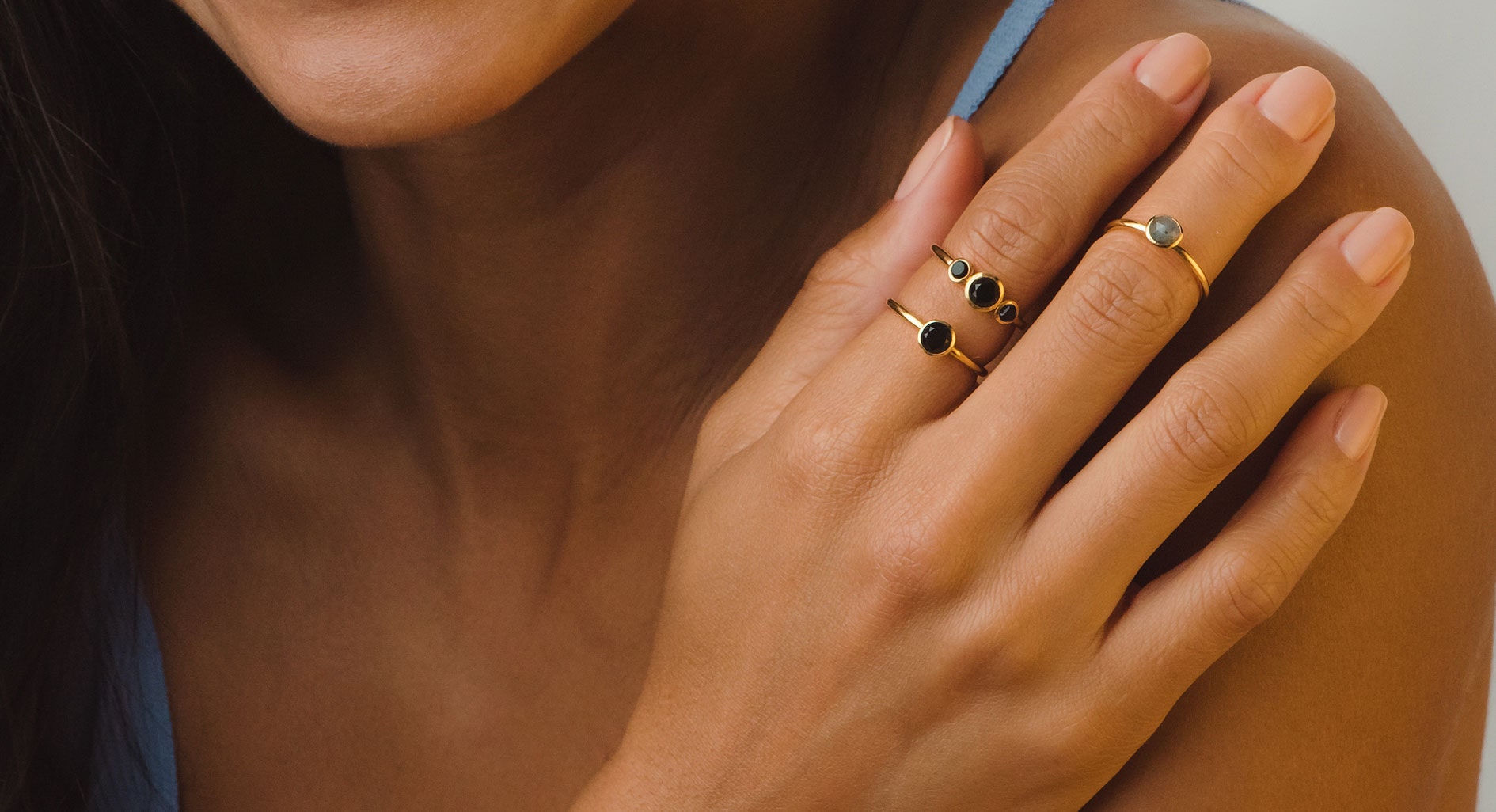 gold ring stack with black onyx gemstone and gold labradorite ring