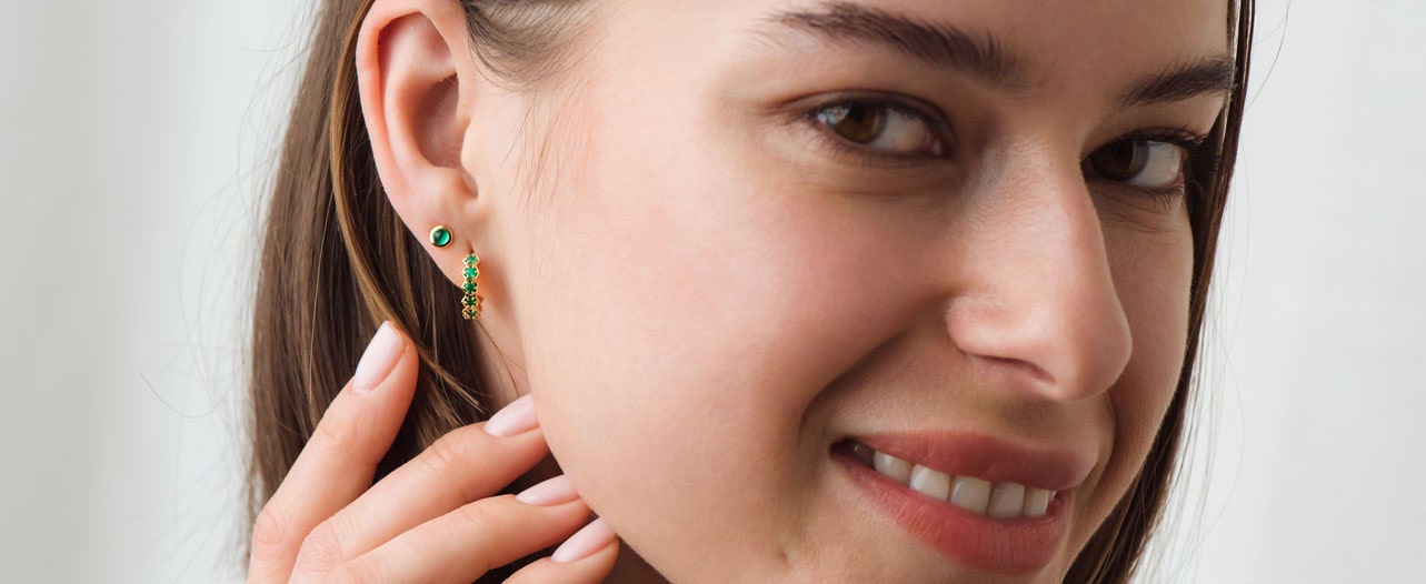 green onyx earring stack with gold huggie hoop earring and gold stud earring