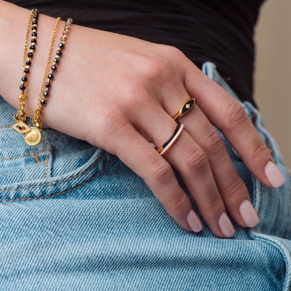 signet ring stacked with enamel rings and biography beaded bracelets