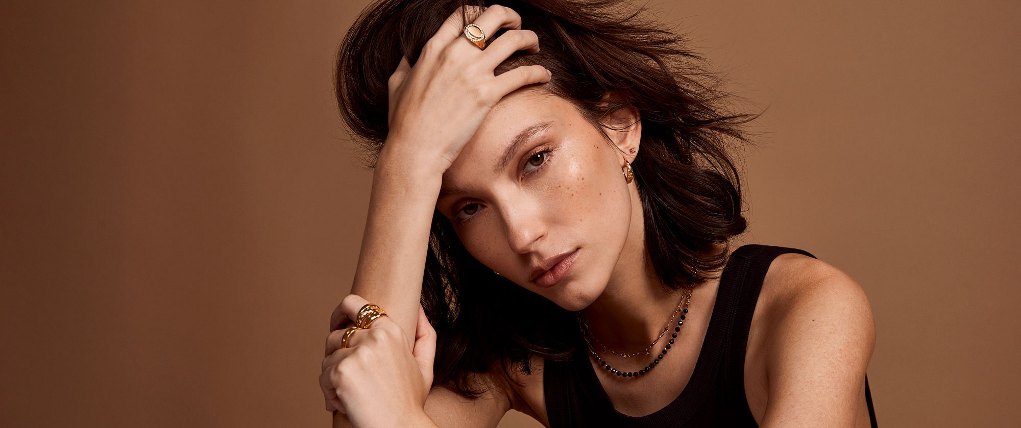 Gold jewellery stack with engraved locket