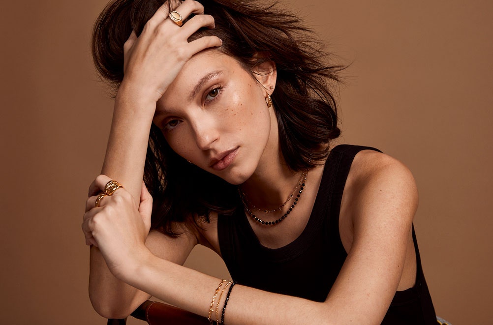 Gold jewellery stack with engraved locket