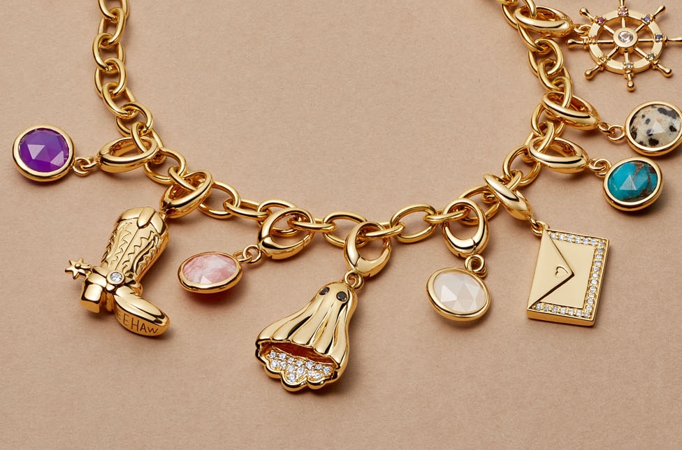 Gold jewelry stack with engraved locket